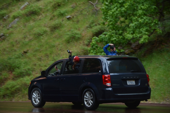 a van of people with cameras hanging out